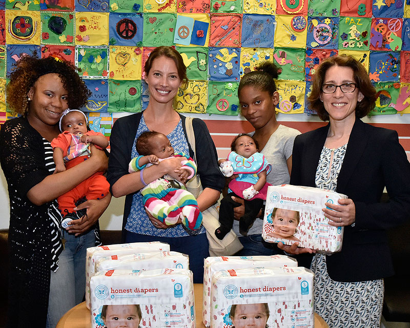 Domestic Violence Bureau Chief Michelle Kaminsky, model Christy Turlington and moms from the Family Justice Center pose with diapers donated by Every Mother Counts organization